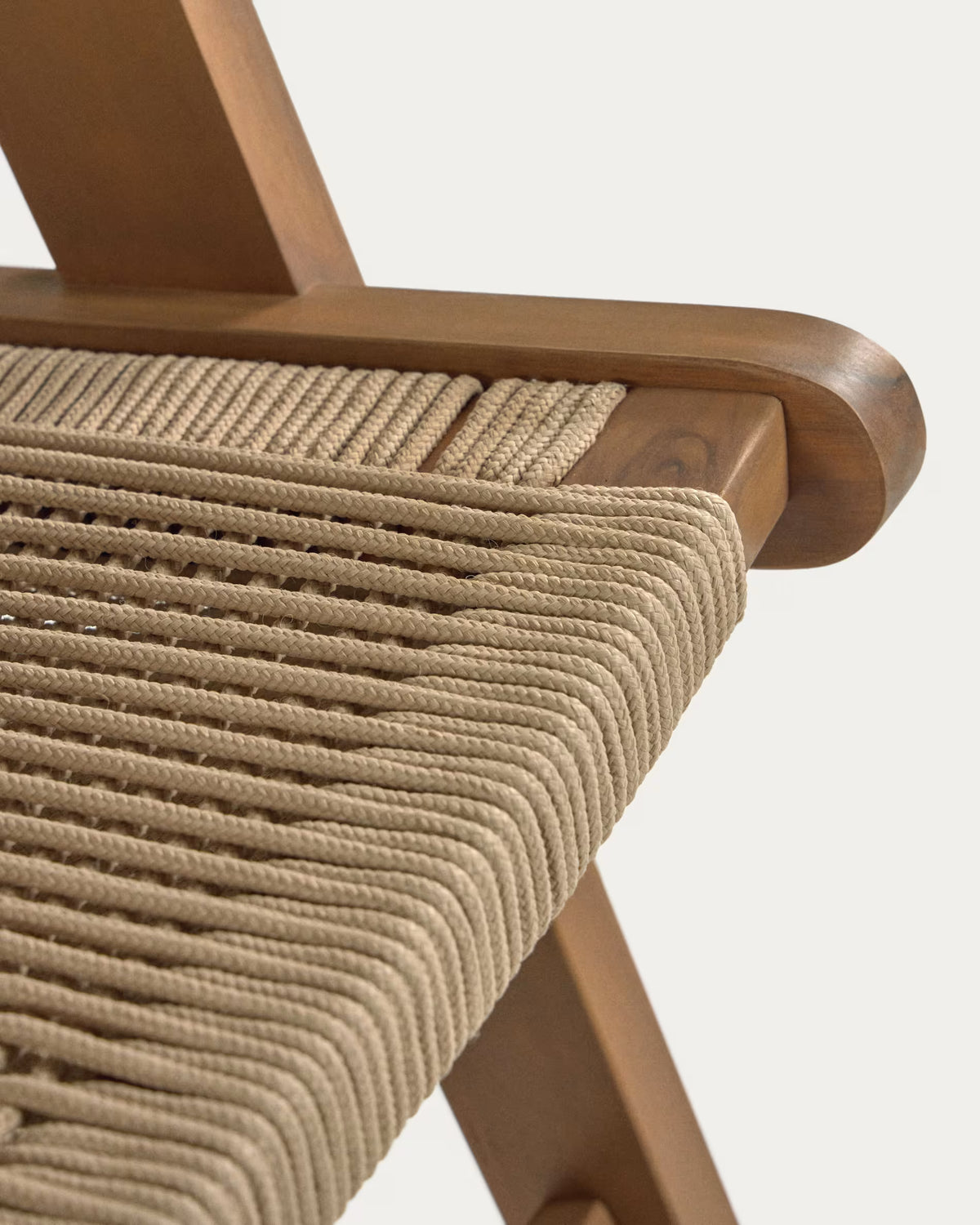 Close-up of a wooden chair with woven seat on a white background